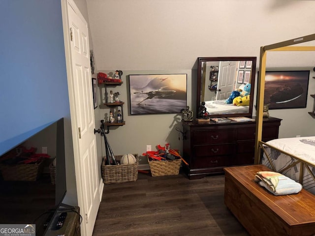 bedroom with dark wood-type flooring