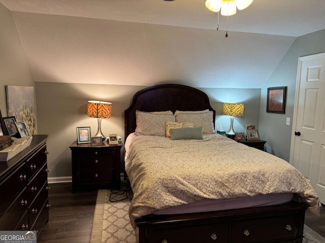 bedroom featuring vaulted ceiling and dark hardwood / wood-style flooring