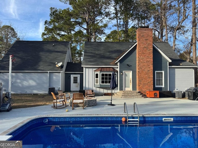 back of house with central AC and a patio