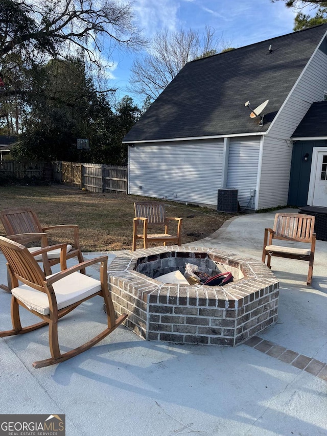 view of patio / terrace with central AC unit and a fire pit