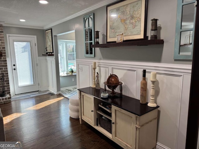 interior space with crown molding, dark hardwood / wood-style floors, and a textured ceiling