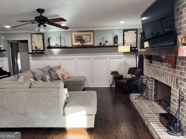 living room with ornamental molding, dark hardwood / wood-style floors, and a brick fireplace