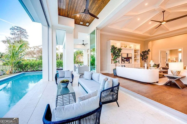 interior space featuring ceiling fan, outdoor lounge area, and a fenced in pool