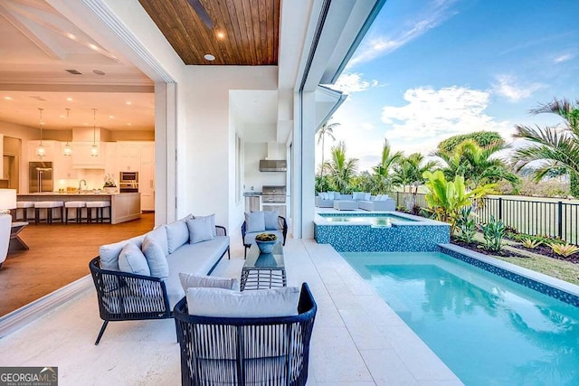 view of pool featuring a fenced backyard, an in ground hot tub, outdoor lounge area, a sink, and a fenced in pool