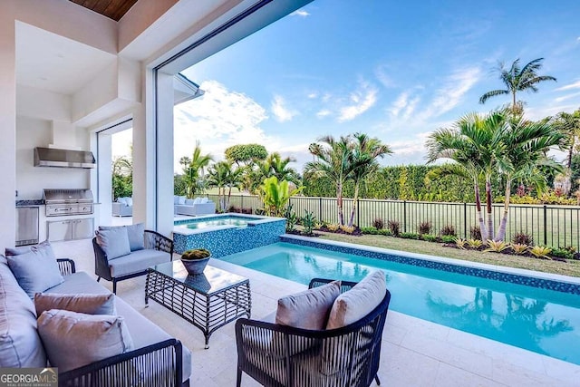 view of swimming pool with a fenced backyard, an outdoor kitchen, a grill, and an outdoor living space