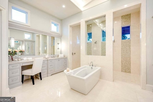 bathroom with tile patterned floors, a freestanding tub, vanity, and a walk in shower