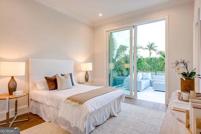 bedroom featuring access to exterior, crown molding, baseboards, and wood finished floors