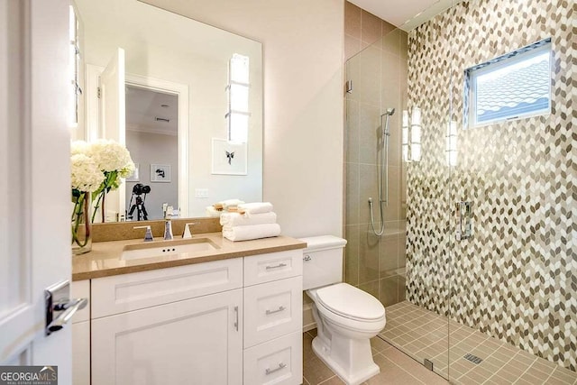 bathroom featuring a stall shower, vanity, toilet, and tile patterned floors