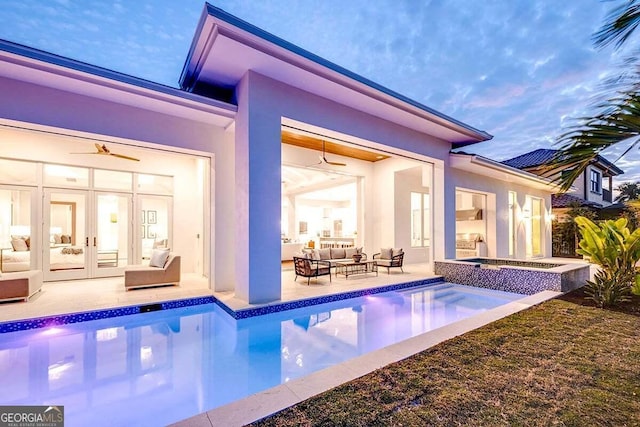 back of property featuring a ceiling fan, a patio, an outdoor hangout area, french doors, and stucco siding