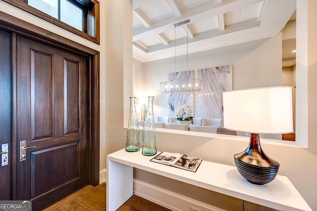 entryway with baseboards, visible vents, coffered ceiling, beamed ceiling, and wood finished floors