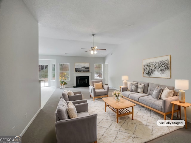 living room featuring lofted ceiling, a healthy amount of sunlight, light colored carpet, and a textured ceiling