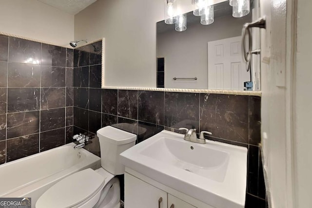 full bathroom featuring vanity, tile walls, shower / bathtub combination, and toilet