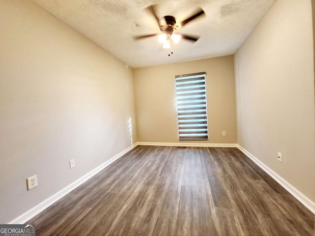 unfurnished room featuring a textured ceiling, dark hardwood / wood-style floors, and ceiling fan