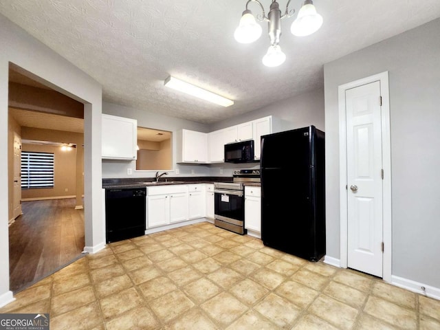 kitchen with pendant lighting, sink, a notable chandelier, black appliances, and white cabinets