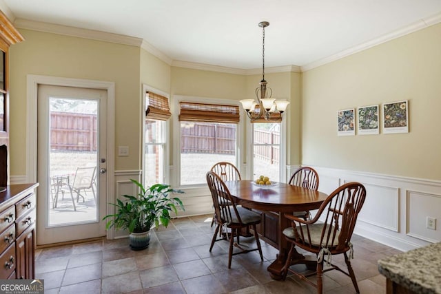 dining space featuring ornamental molding and a chandelier