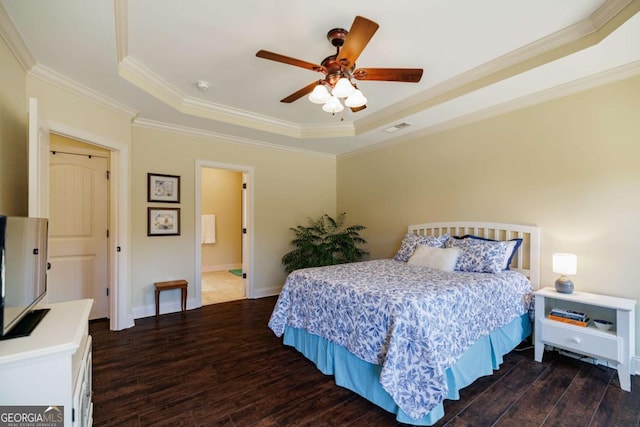 bedroom featuring a tray ceiling, ornamental molding, and dark hardwood / wood-style floors