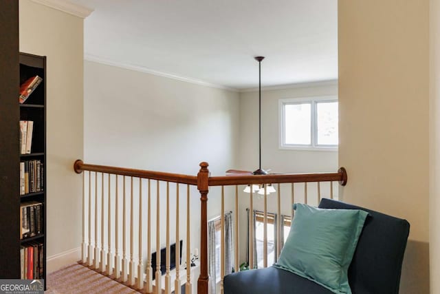 hall featuring ornamental molding and carpet floors