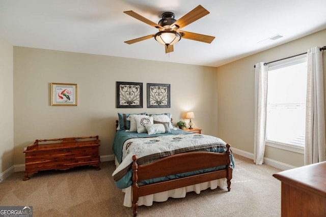 bedroom featuring ceiling fan and light carpet