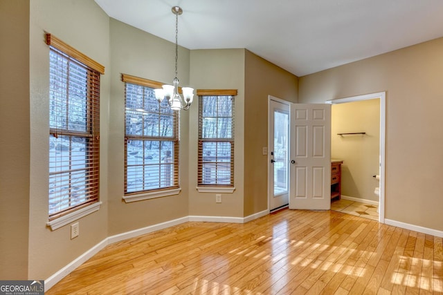 entryway with light hardwood / wood-style flooring and a chandelier