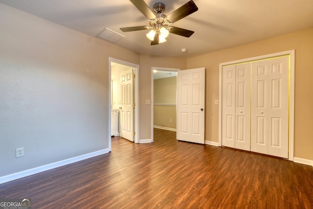 unfurnished bedroom featuring dark hardwood / wood-style floors, ceiling fan, and a closet