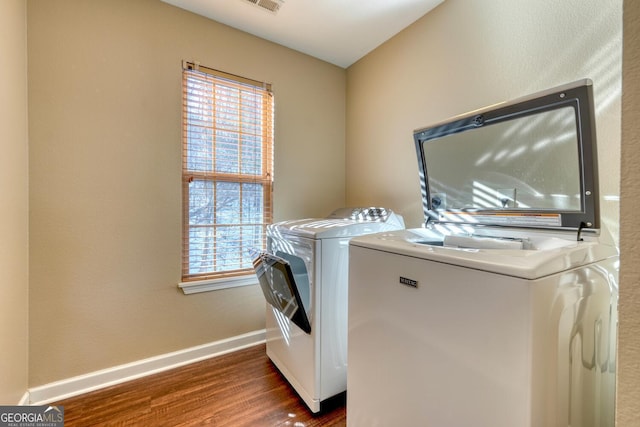 laundry room featuring dark wood-type flooring and independent washer and dryer