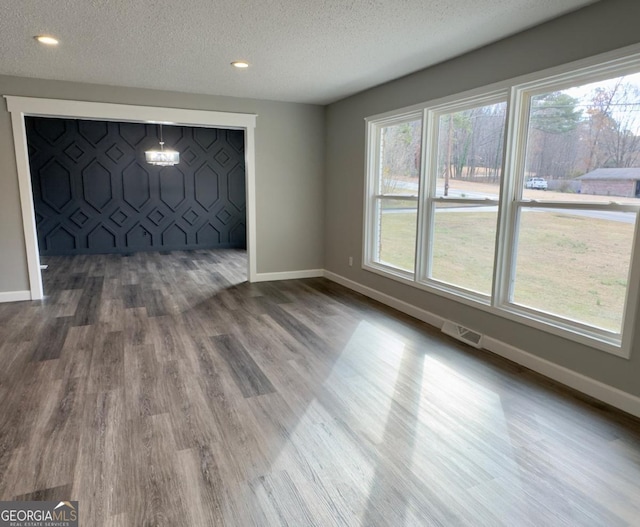 interior space featuring hardwood / wood-style floors and a textured ceiling