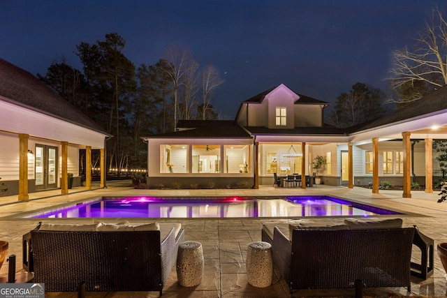 pool at twilight with a patio