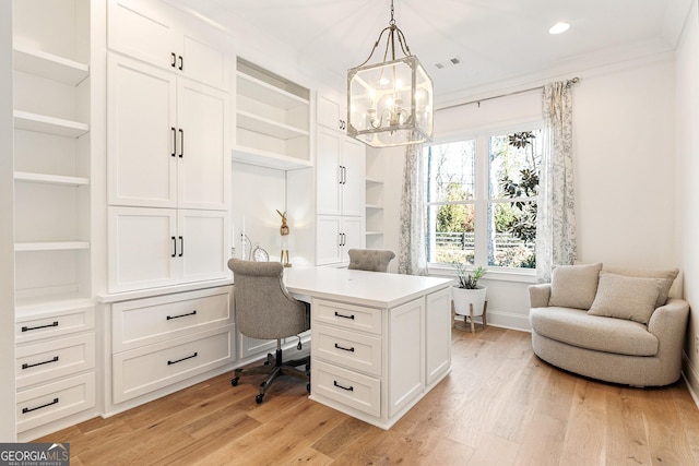 office area featuring ornamental molding, a chandelier, built in features, and light wood-type flooring