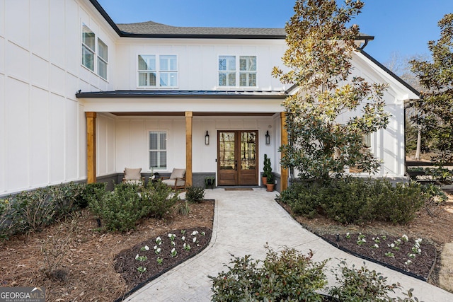 property entrance featuring covered porch and french doors