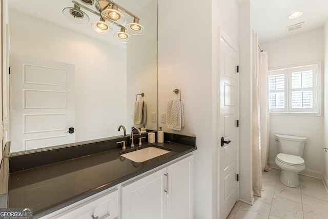 bathroom featuring vanity and toilet