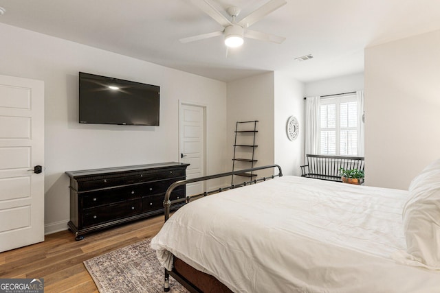 bedroom with wood-type flooring and ceiling fan