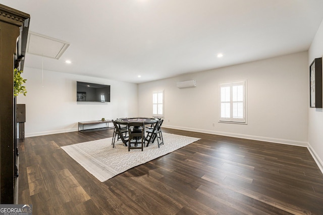 dining area with dark wood-type flooring and a wall mounted AC