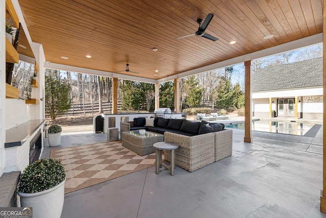 view of patio with an outdoor living space, area for grilling, and ceiling fan