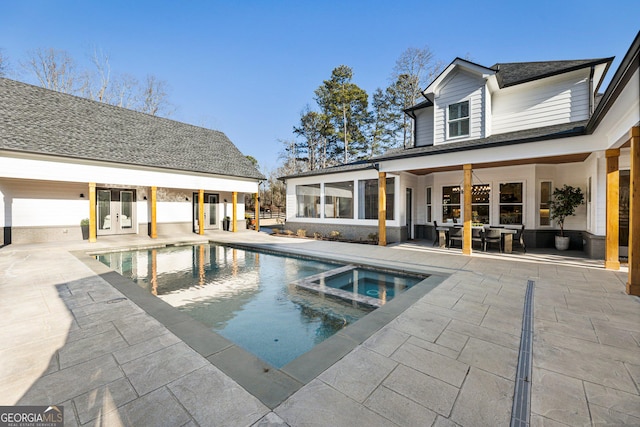 view of swimming pool with a patio and an in ground hot tub