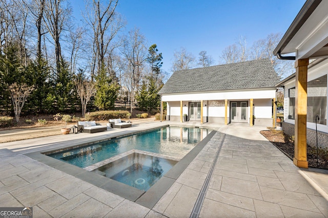 view of pool with an outbuilding, a patio, and an in ground hot tub