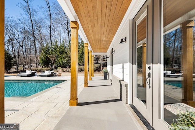 view of swimming pool featuring a patio area