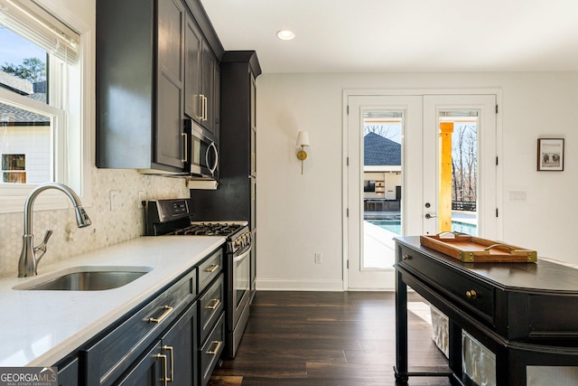 kitchen with dark hardwood / wood-style floors, tasteful backsplash, sink, stainless steel appliances, and french doors