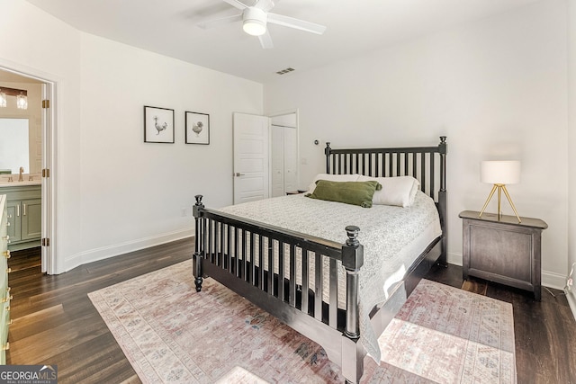 bedroom with ceiling fan, connected bathroom, dark hardwood / wood-style flooring, and sink