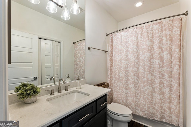 bathroom featuring vanity and toilet