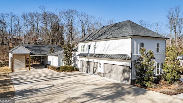 view of side of property with a garage and a carport