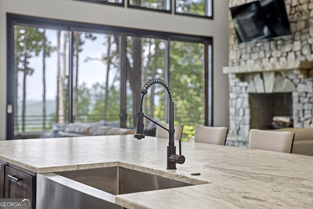 kitchen featuring a fireplace, sink, and a wealth of natural light