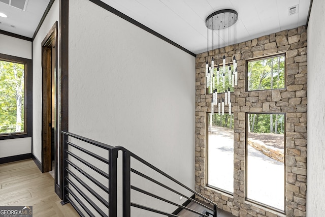 interior space featuring crown molding, hardwood / wood-style flooring, and plenty of natural light