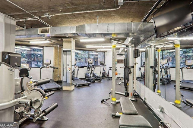 workout area with visible vents and concrete block wall