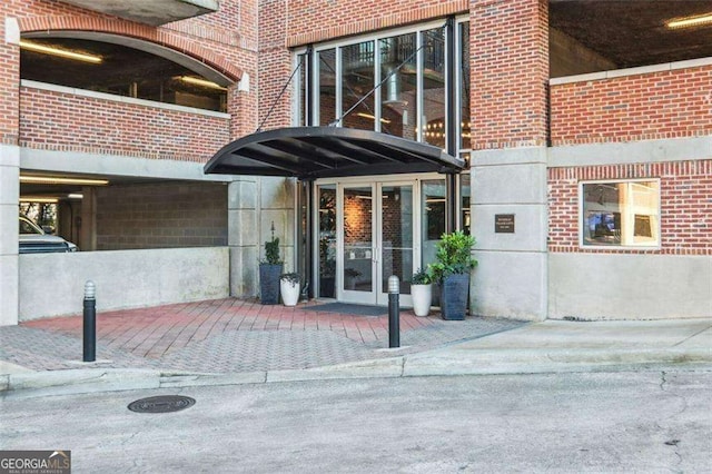 property entrance with french doors and brick siding