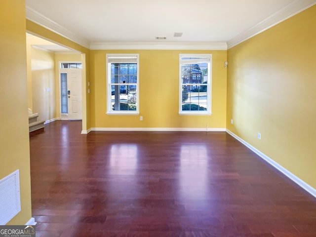 empty room featuring crown molding and dark hardwood / wood-style floors