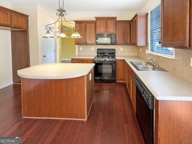 kitchen with sink, hanging light fixtures, black appliances, a kitchen island, and dark hardwood / wood-style flooring