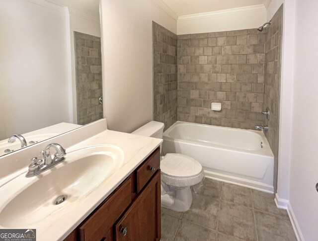 full bathroom featuring vanity, tiled shower / bath combo, ornamental molding, and toilet