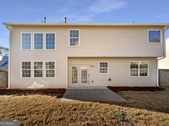 rear view of house with a patio and a yard