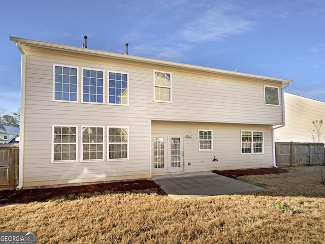 rear view of property with a patio area and a lawn