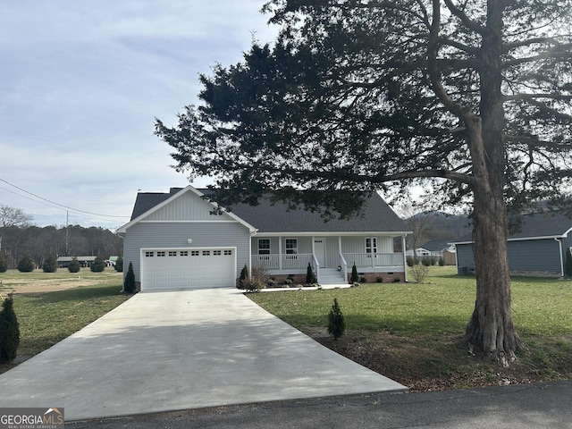 view of front of home with a garage, covered porch, and a front lawn